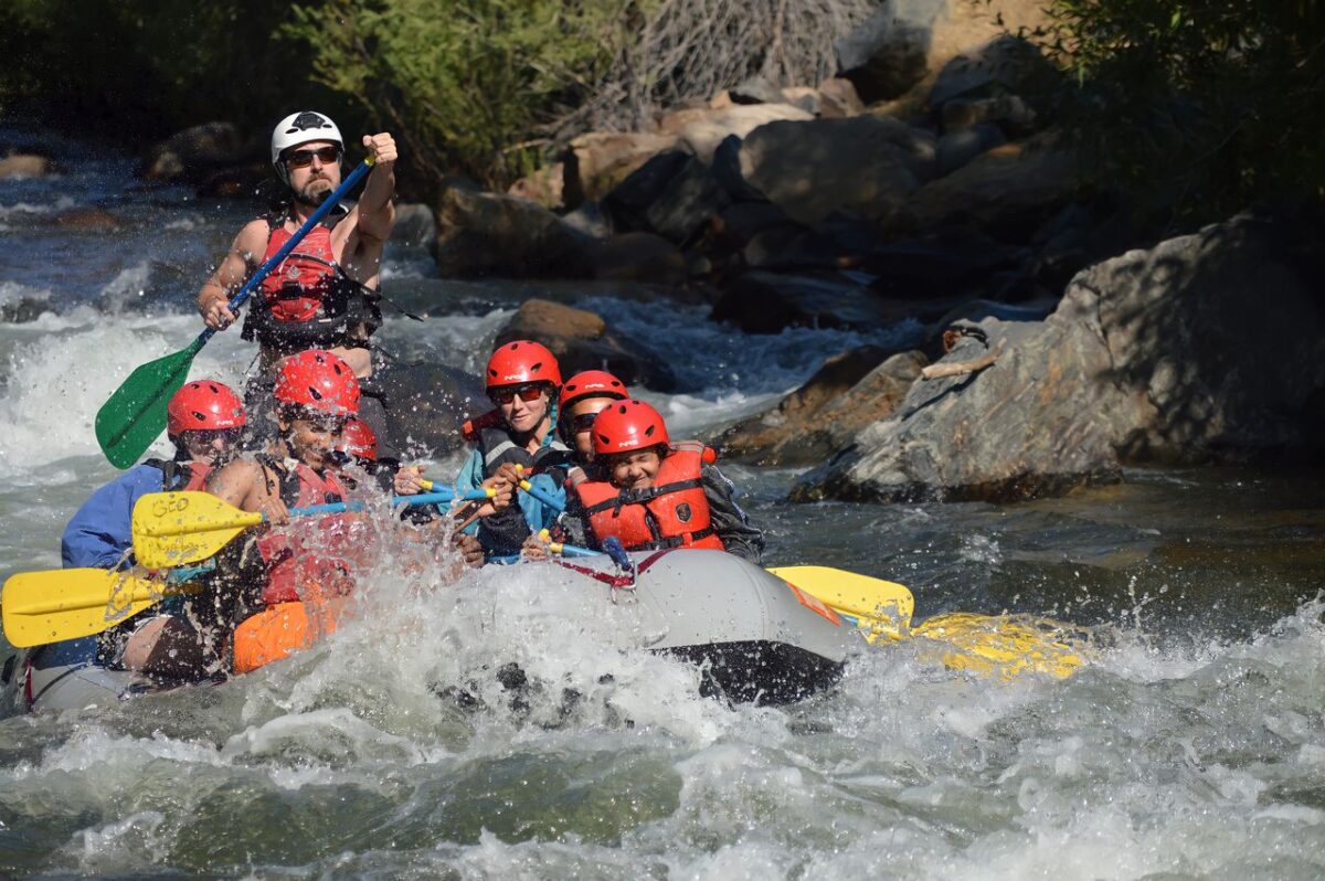 Offres Group enjoying a thrilling whitewater rafting experience on a rapid river.